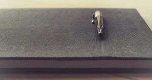 close up image of a pen resting on a lawyer's book