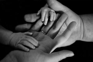 image of baby hands holding adult hands