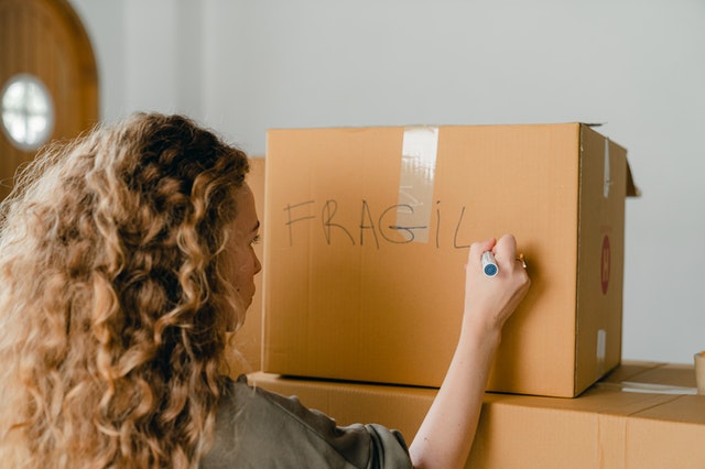 Woman writing on box