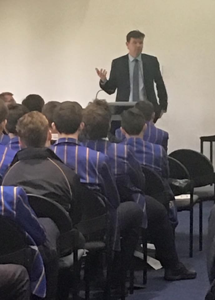 Dean Spanner lawyer on a podium speaking to high school students