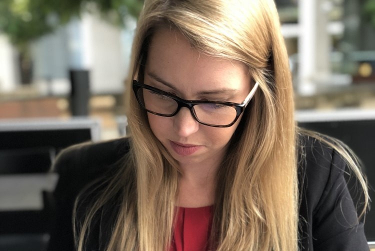 Person in glasses looking down|Kennedy Spanner Lawyer Rachel Duckworth