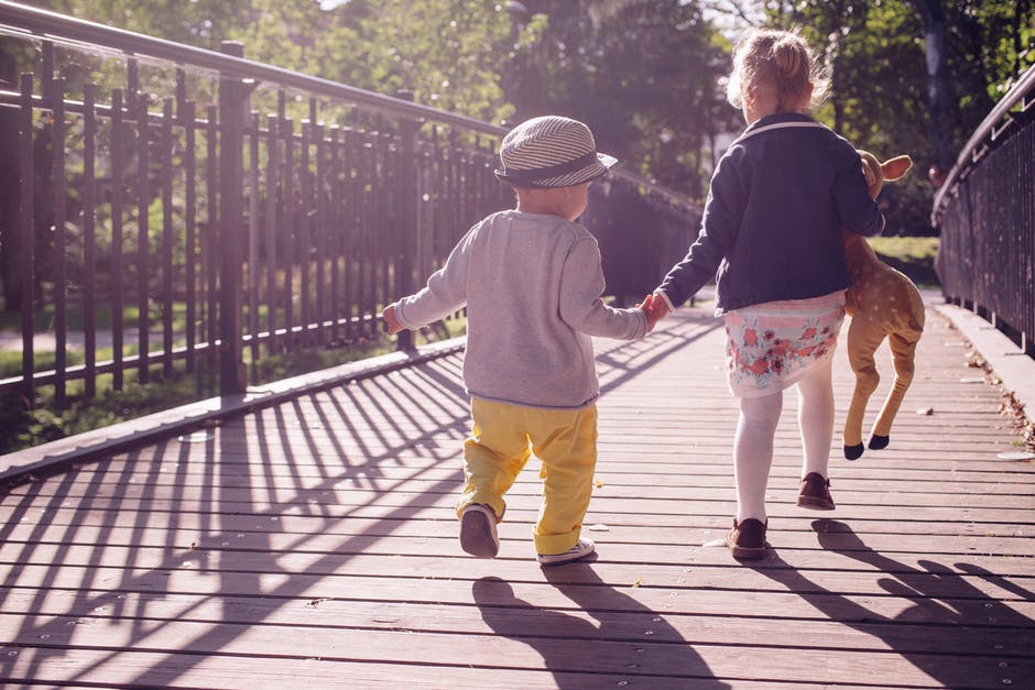 children walking along boardwalk